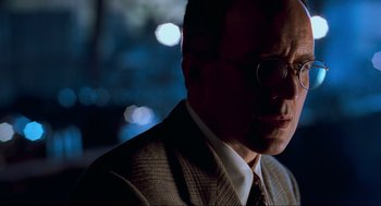 Movie still from “The Lost World: Jurassic Park” (1997), directed by Steven Spielberg – A person wearing a suit and tie; Close Up shot, Low angle