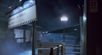 Movie still from “The Lost World: Jurassic Park” (1997), directed by Steven Spielberg – A street light lit up at night in the dark; Extreme Wide shot, Low angle