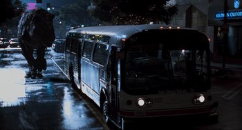 Movie still from “The Lost World: Jurassic Park” (1997), directed by Steven Spielberg – A city bus driving down a street at night; Extreme Wide shot, High angle