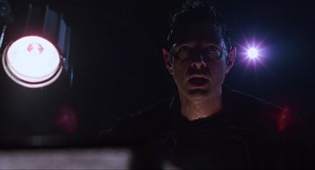 Movie still from “The Lost World: Jurassic Park” (1997), directed by Steven Spielberg – A person wearing glasses in the dark; Close Up shot, Low angle