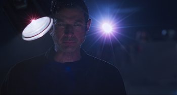 Movie still from “The Lost World: Jurassic Park” (1997), directed by Steven Spielberg – A man is standing in front of a light; Close Up shot, Low angle