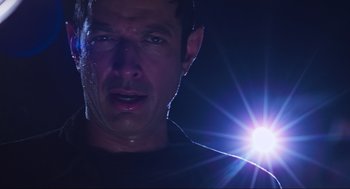 Movie still from “The Lost World: Jurassic Park” (1997), directed by Steven Spielberg – A person with a light in the background; Close Up shot, Low angle