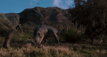 Movie still from “The Lost World: Jurassic Park” (1997), directed by Steven Spielberg – An image of an animal in the grass near a mountain; Extreme Wide shot, Low angle