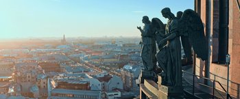 Movie still from “The Machine” (2023), directed by Peter Atencio – A view of a city from the top of a building; Extreme Wide shot, High angle