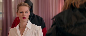 Movie still from “The Machine” (2023), directed by Peter Atencio – A woman in a white shirt and a man in a balaclava; Close Up shot, Over the shoulder angle