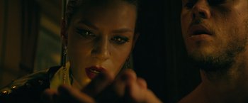 Movie still from “The Machine” (2023), directed by Peter Atencio – A person putting lipstick on; Close Up shot, Low angle