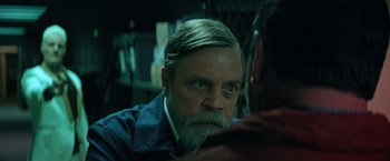 Movie still from “The Machine” (2023), directed by Peter Atencio – A person with a beard; Close Up shot, Over the shoulder angle