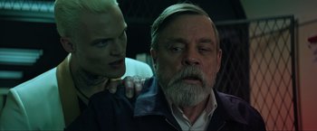 Movie still from “The Machine” (2023), directed by Peter Atencio – An older man and a younger man are looking at one another; Close Up shot, Over the shoulder angle