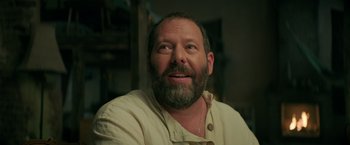 Movie still from “The Machine” (2023), directed by Peter Atencio – A man with a goatee and beard looking up; Close Up shot, Low angle