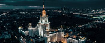 Movie still from “The Machine” (2023), directed by Peter Atencio – A view of a city at night from a helicopter; Extreme Wide shot, Low angle