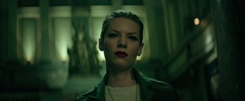 Movie still from “The Machine” (2023), directed by Peter Atencio – A person wearing a green jacket; Close Up shot, Low angle