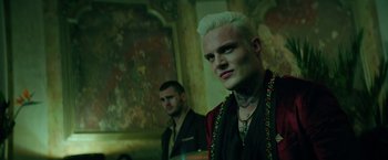 Movie still from “The Machine” (2023), directed by Peter Atencio – A man with white hair is standing next to another man; Close Up shot, Low angle