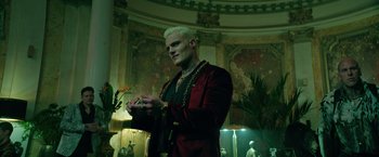 Movie still from “The Machine” (2023), directed by Peter Atencio – A man with white hair is wearing a red jacket; Medium shot, Low angle