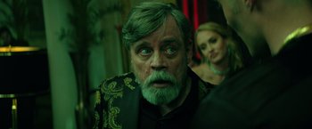 Movie still from “The Machine” (2023), directed by Peter Atencio – A person with a beard; Close Up shot, Over the shoulder angle