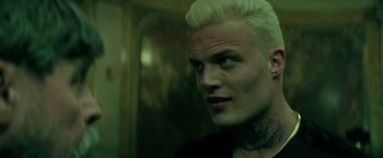 Movie still from “The Machine” (2023), directed by Peter Atencio – A person wearing a black shirt; Close Up shot, Over the shoulder angle