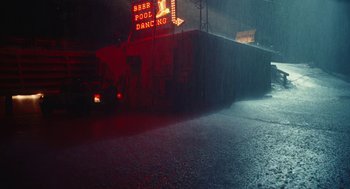 Movie still from “Euphoria” (2019), created by Sam Levinson – A wet street with a red neon sign on the side of the road; Extreme Wide shot, Low angle