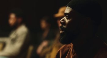 Movie still from “Euphoria” (2019), created by Sam Levinson – A man with a beard is looking into the distance; Close Up shot, Over the shoulder angle