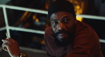 Movie still from “Euphoria” (2019), created by Sam Levinson – A man with a beard is sitting in front of some lights; Close Up shot, Low angle