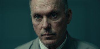 Movie still from “Dopesick” (2021), directed by Danny Strong – An older man wearing a suit and tie looking at the camera; Close Up shot, Low angle