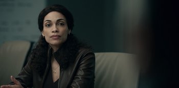 Movie still from “Dopesick” (2021), directed by Danny Strong – A woman sitting on top of a couch wearing a leather jacket; Close Up shot, Over the shoulder angle