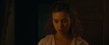 Movie still from “The Mad Women's Ball” (2021), directed by Mélanie Laurent – A young woman is looking at the camera; Close Up shot, Over the shoulder angle