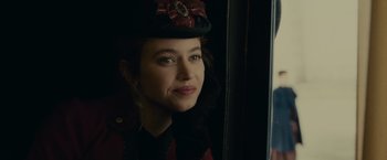 Movie still from “The Mad Women's Ball” (2021), directed by Mélanie Laurent – A person wearing a hat; Close Up shot, Over the shoulder angle