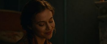 Movie still from “The Mad Women's Ball” (2021), directed by Mélanie Laurent – A person with eyes closed smiling; Close Up shot, Over the shoulder angle