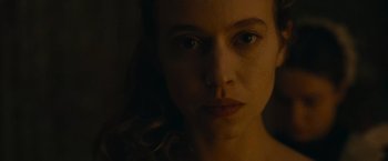 Movie still from “The Mad Women's Ball” (2021), directed by Mélanie Laurent – A woman's face in the dark; Close Up shot, Low angle