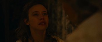 Movie still from “The Mad Women's Ball” (2021), directed by Mélanie Laurent – A person looking up at something; Close Up shot, Over the shoulder angle