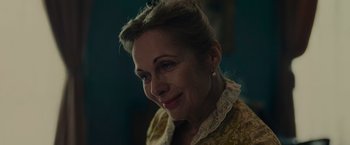 Movie still from “The Mad Women's Ball” (2021), directed by Mélanie Laurent – A person wearing a yellow shirt; Close Up shot, High angle