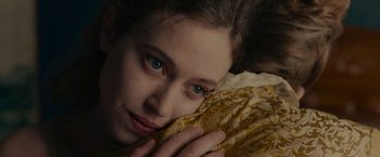 Movie still from “The Mad Women's Ball” (2021), directed by Mélanie Laurent – A person laying on the ground; Close Up shot, Overhead angle