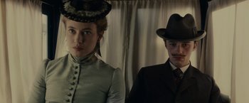 Movie still from “The Mad Women's Ball” (2021), directed by Mélanie Laurent – A man and a woman standing next to each other; Close Up shot, Low angle