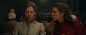 Movie still from “The Mad Women's Ball” (2021), directed by Mélanie Laurent – Two women are standing next to each other; Close Up shot, Over the shoulder angle