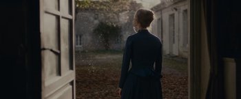 Movie still from “The Mad Women's Ball” (2021), directed by Mélanie Laurent – A woman standing in front of an open window; Medium shot, Over the shoulder angle