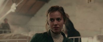 Movie still from “The Mad Women's Ball” (2021), directed by Mélanie Laurent – A person wearing a jacket; Close Up shot, Over the shoulder angle