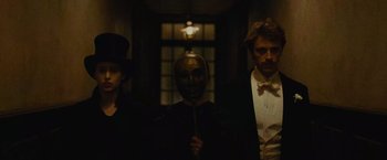 Movie still from “The Mad Women's Ball” (2021), directed by Mélanie Laurent – A group of men standing next to each other; Medium shot, Low angle