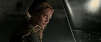 Movie still from “The Man from U.N.C.L.E.” (2015), directed by Guy Ritchie – A woman wearing a head scarf looking into the distance; Close Up shot, Low angle