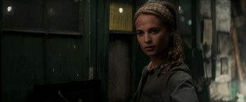 Movie still from “The Man from U.N.C.L.E.” (2015), directed by Guy Ritchie – A woman with a head scarf is looking at the camera; Close Up shot, Over the shoulder angle