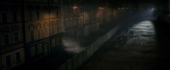 Movie still from “The Man from U.N.C.L.E.” (2015), directed by Guy Ritchie – A city street at night lit by street lights; Extreme Wide shot, High angle