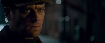 Movie still from “The Man from U.N.C.L.E.” (2015), directed by Guy Ritchie – A man wearing a hat; Close Up shot, Over the shoulder angle