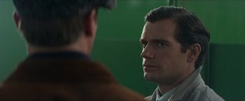Movie still from “The Man from U.N.C.L.E.” (2015), directed by Guy Ritchie – A man looking at another man in front of a green screen; Close Up shot, Over the shoulder angle