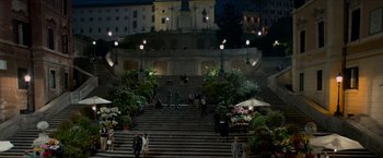 Movie still from “The Man from U.N.C.L.E.” (2015), directed by Guy Ritchie – A group of people standing on top of a set of stairs; Extreme Wide shot, High angle