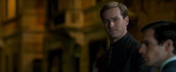 Movie still from “The Man from U.N.C.L.E.” (2015), directed by Guy Ritchie – A person wearing a suit and tie; Close Up shot, Over the shoulder angle