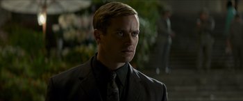 Movie still from “The Man from U.N.C.L.E.” (2015), directed by Guy Ritchie – A person wearing a suit and tie; Close Up shot, Over the shoulder angle