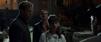 Movie still from “The Man from U.N.C.L.E.” (2015), directed by Guy Ritchie – A group of people standing next to each other in a room; Medium shot, Low angle