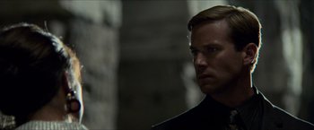 Movie still from “The Man from U.N.C.L.E.” (2015), directed by Guy Ritchie – A person wearing a black jacket; Close Up shot, Over the shoulder angle