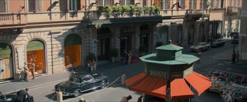Movie still from “The Man from U.N.C.L.E.” (2015), directed by Guy Ritchie – An old car parked on the side of the street; Extreme Wide shot, High angle