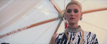 Movie still from “The Man from U.N.C.L.E.” (2015), directed by Guy Ritchie – A woman in a black and white dress with a necklace; Close Up shot, Low angle