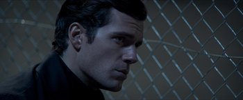 Movie still from “The Man from U.N.C.L.E.” (2015), directed by Guy Ritchie – A person wearing a black shirt; Close Up shot, Over the shoulder angle