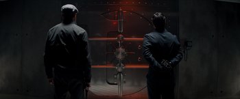 Movie still from “The Man from U.N.C.L.E.” (2015), directed by Guy Ritchie – Two men standing in front of a bank vault door; Medium shot, Low angle